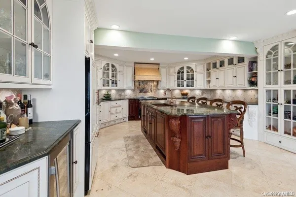 a kitchen with stainless steel appliances granite countertop a sink stove and cabinets