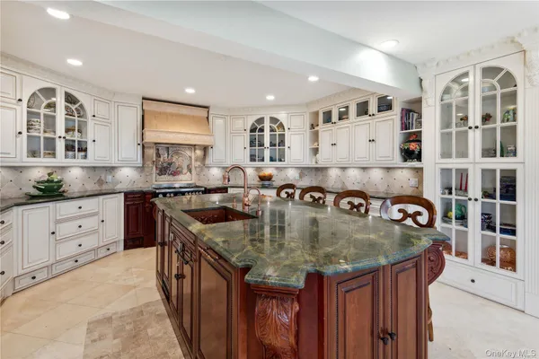 a kitchen with stainless steel appliances granite countertop a sink a stove and a refrigerator