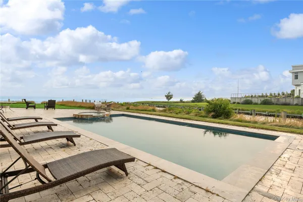 a view of swimming pool with outdoor seating and city view