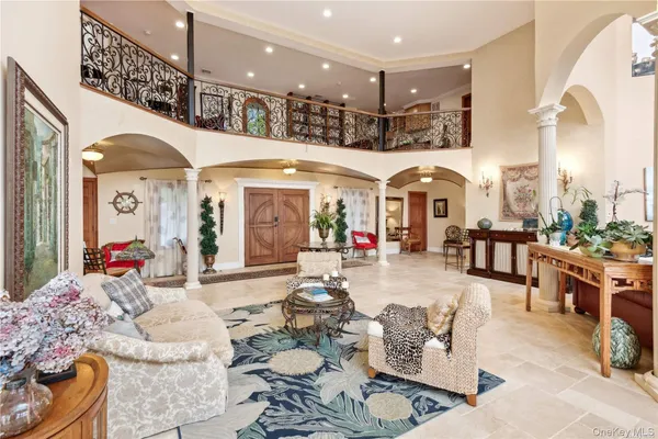 a living room with couches a dining table and chairs with outer view