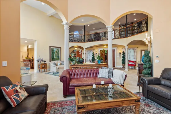 a living room with furniture a rug and white walls