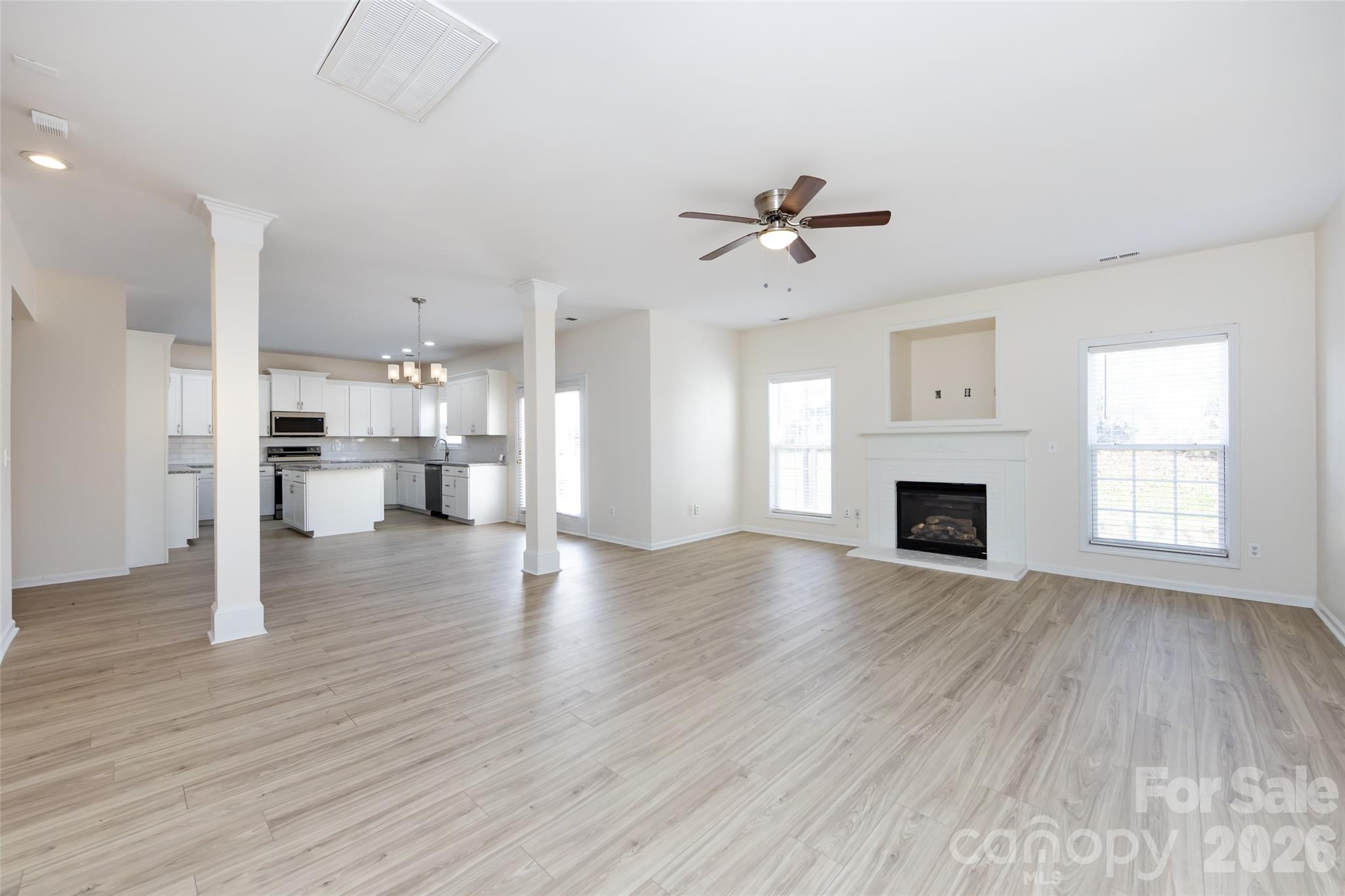 2705 Gosling Terrace Road Charlotte, NC 28262 - Photo 14 of 36 a view of empty room with wooden floor and fireplace