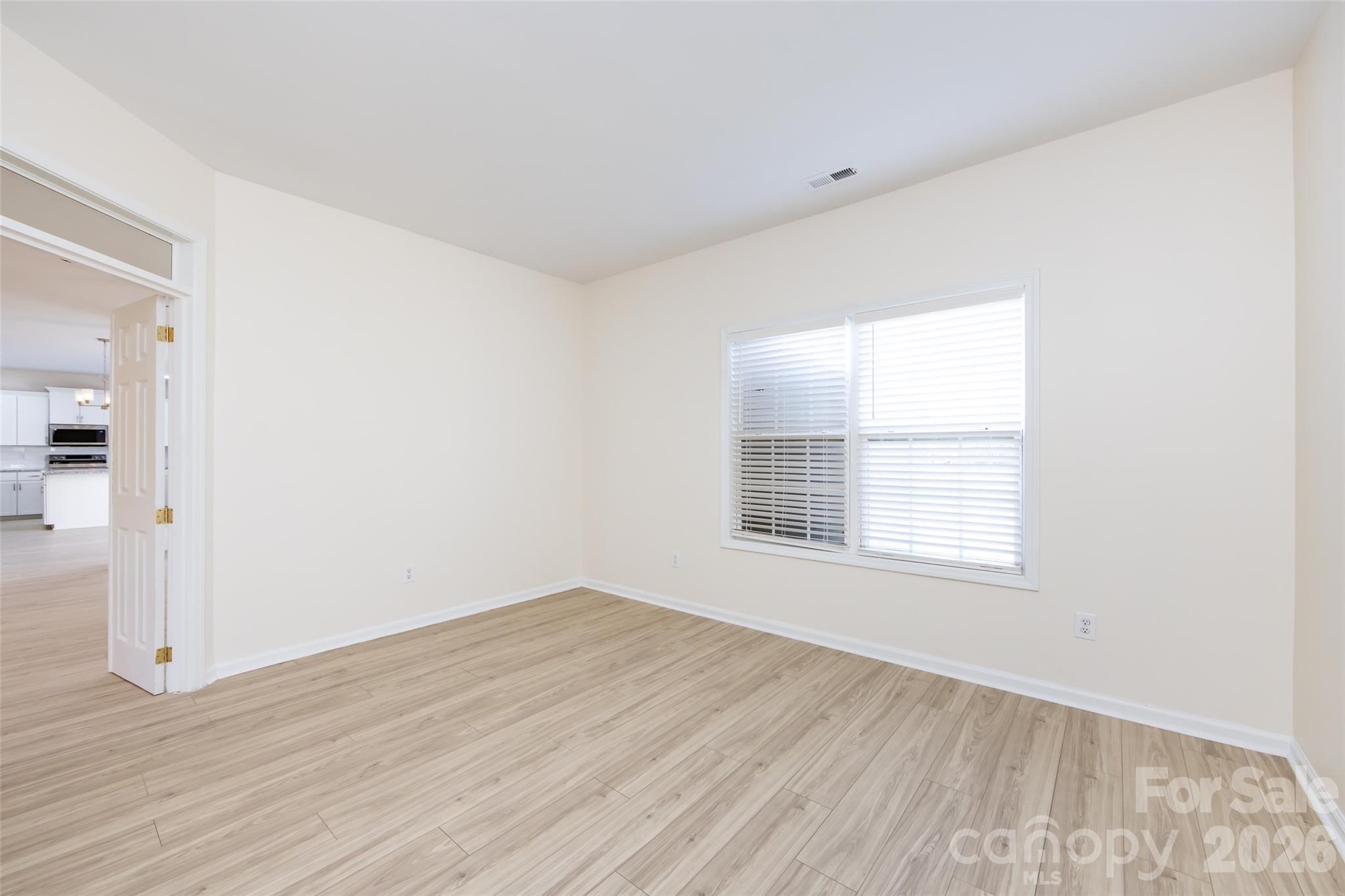 2705 Gosling Terrace Road Charlotte, NC 28262 - Photo 18 of 36 an empty room with wooden floor and windows