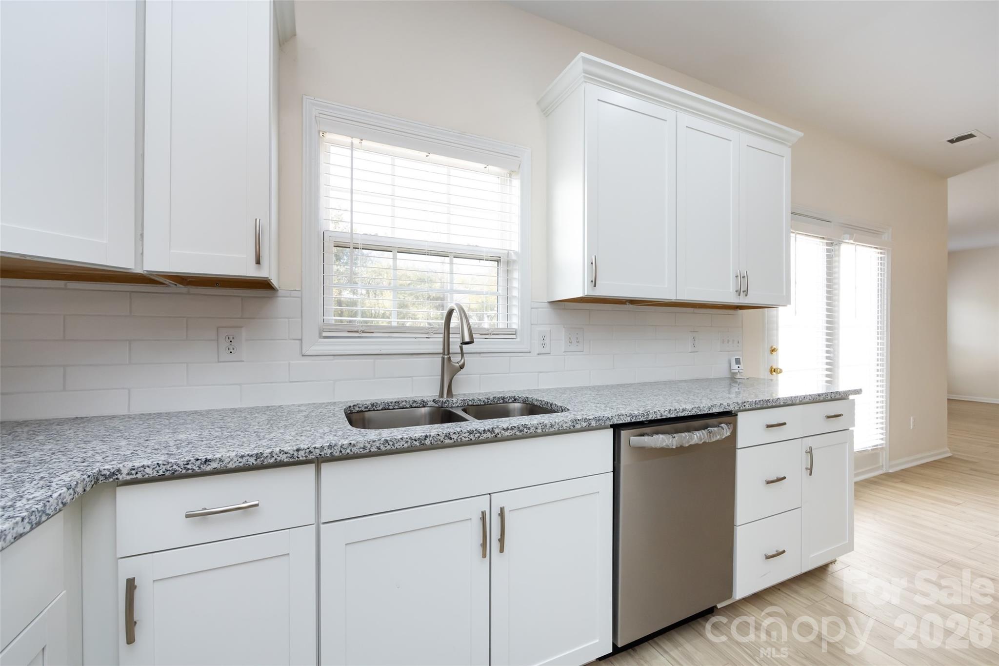 2705 Gosling Terrace Road Charlotte, NC 28262 - Photo 28 of 36 a kitchen with granite countertop white cabinets and white appliances