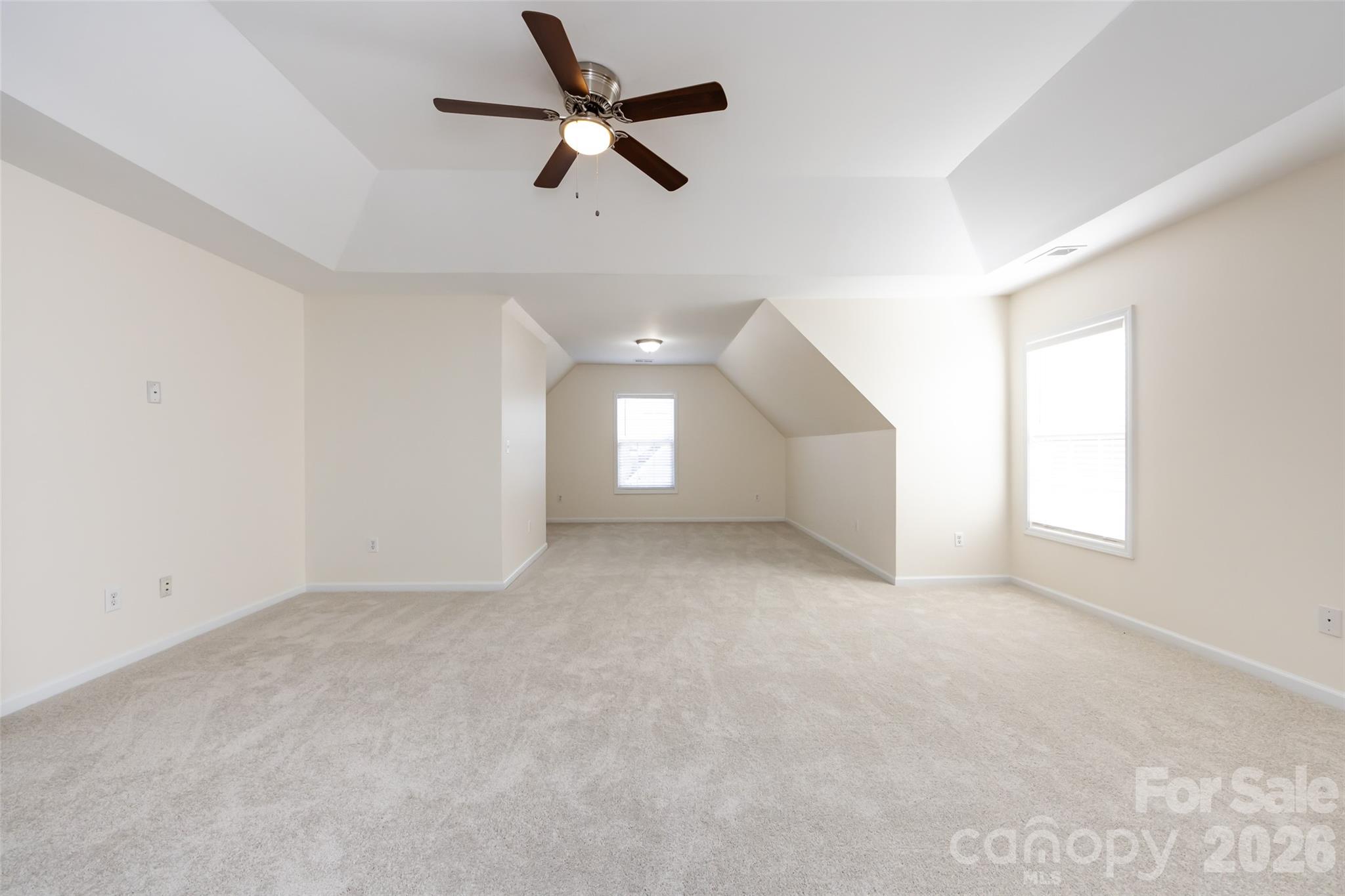 2705 Gosling Terrace Road Charlotte, NC 28262 - Photo 33 of 36 an empty room with a ceiling fan and windows