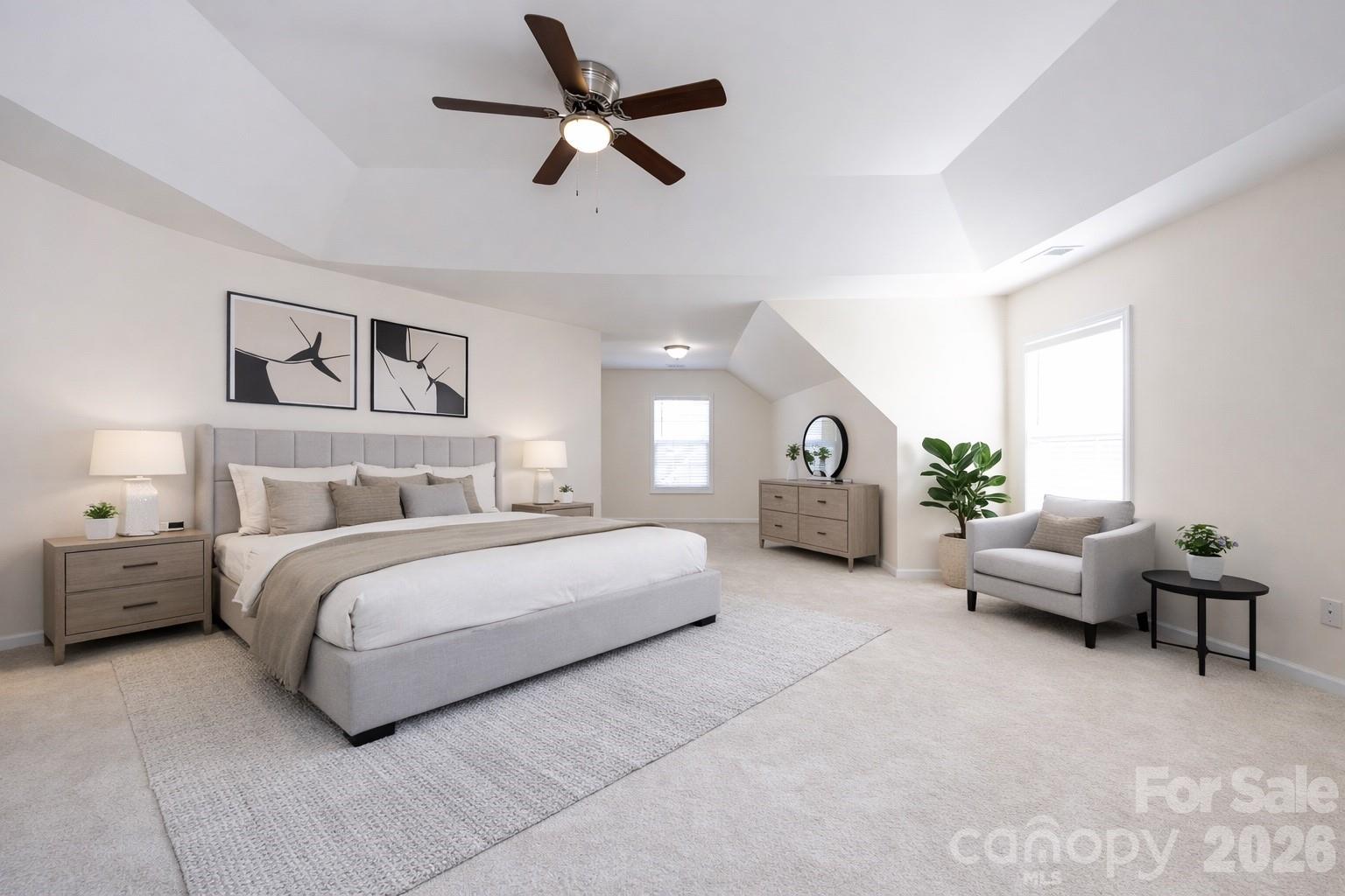 2705 Gosling Terrace Road Charlotte, NC 28262 - Photo 34 of 36 a spacious bedroom with a bed a couch and a ceiling fan