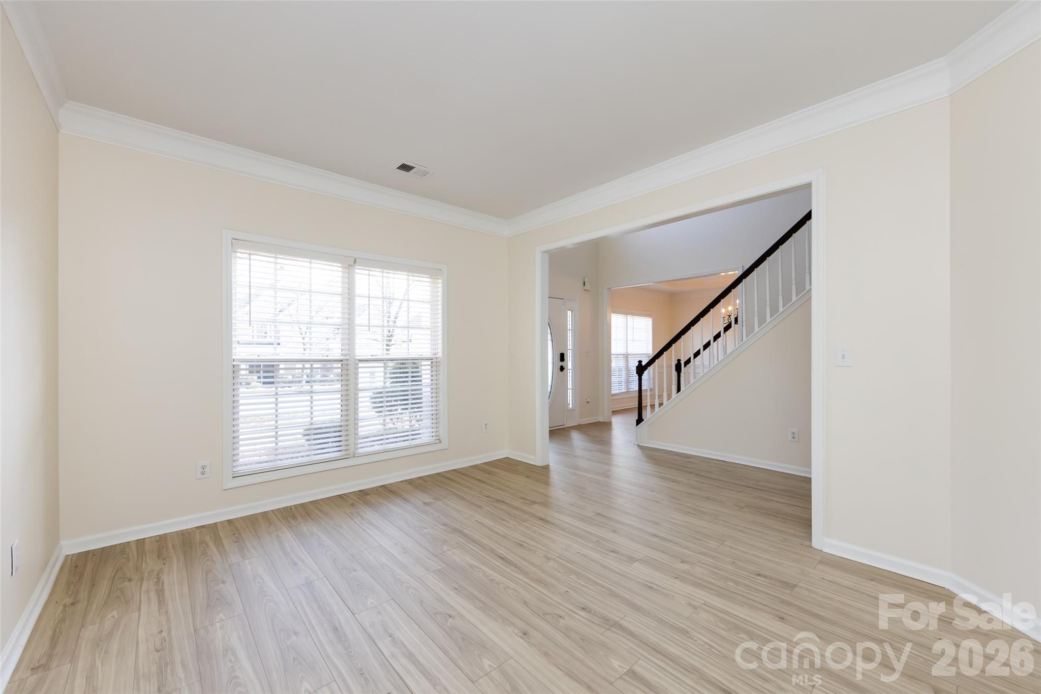 2705 Gosling Terrace Road Charlotte, NC 28262 - Photo 10 of 36 a view of an empty room with wooden floor and stairs