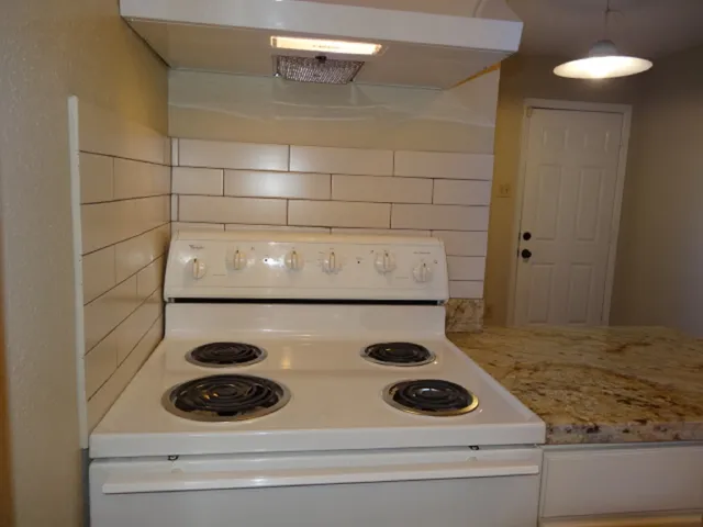 a kitchen with a refrigerator and a stove