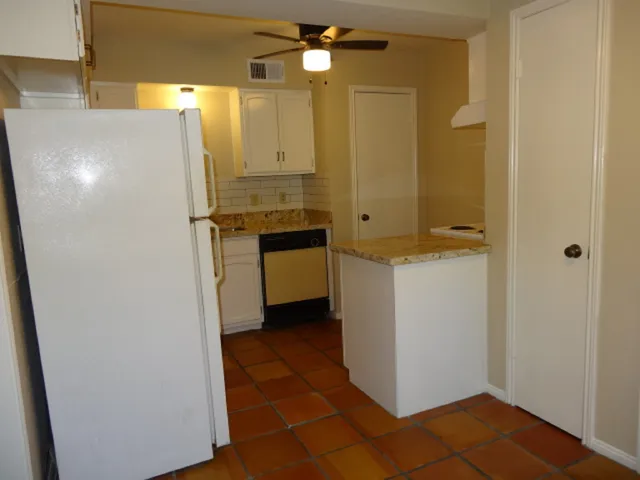 a white refrigerator freezer sitting inside of a kitchen