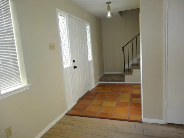a view of staircase with wooden floor and white walls