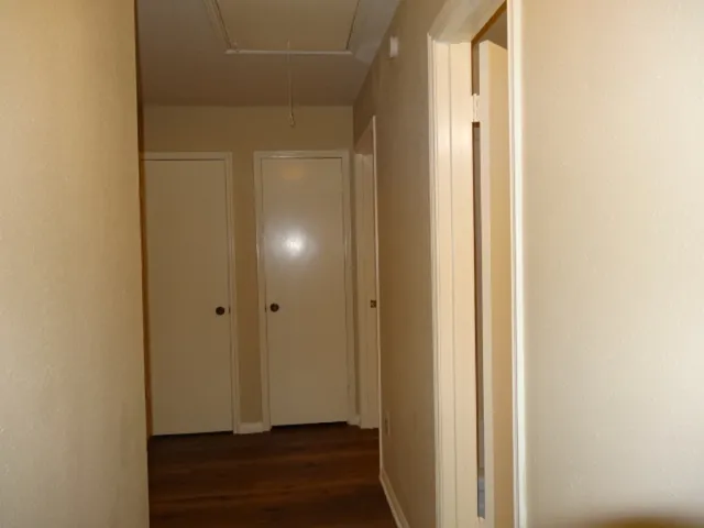 a bathroom with a granite countertop sink and a toilet