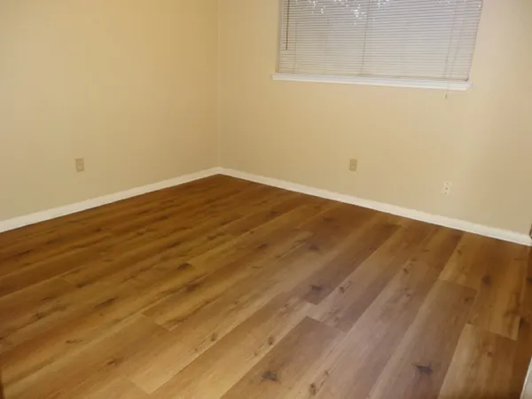 a view of a room with wooden floor