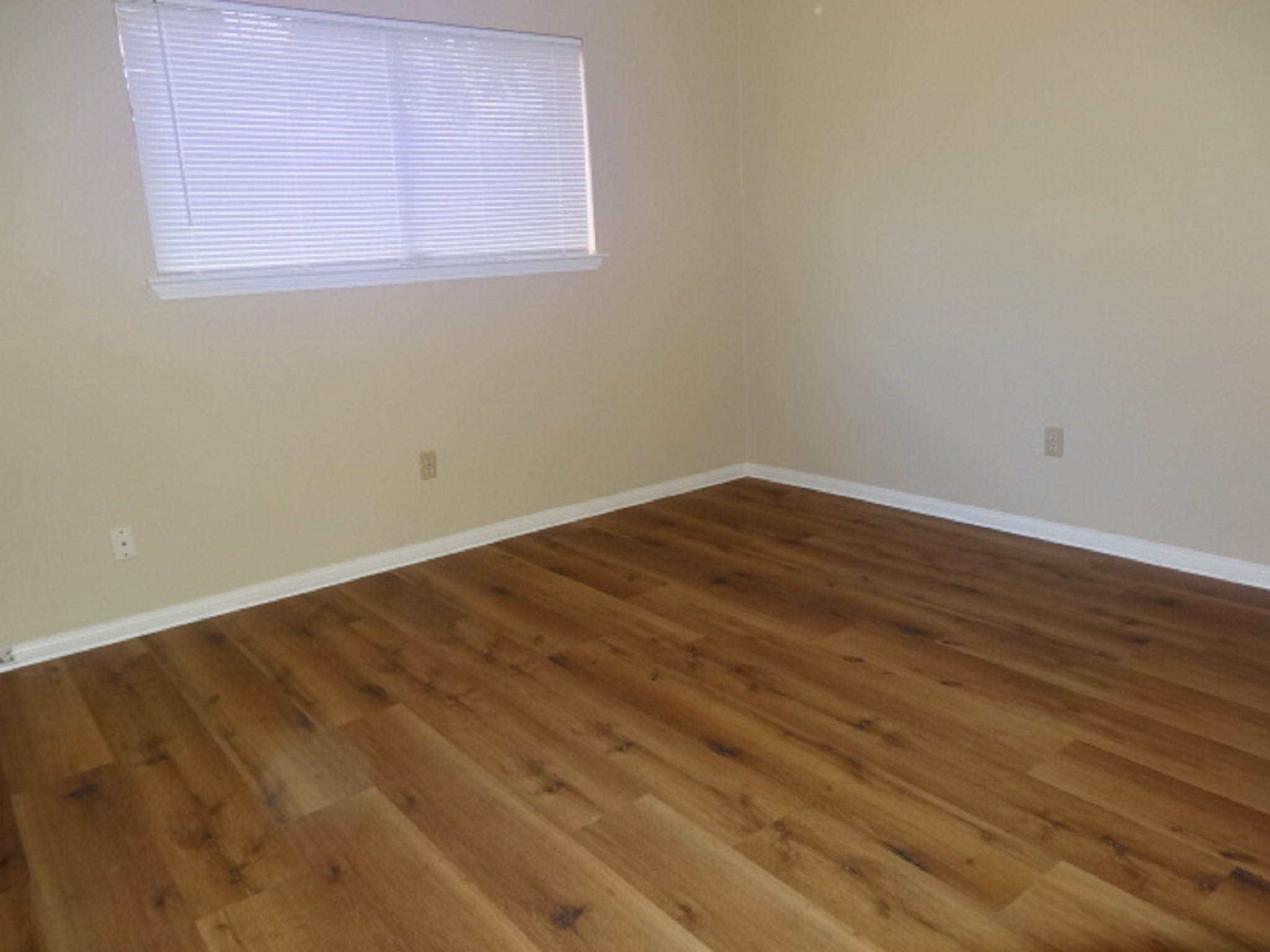 5522 Deep Forest Drive Houston, TX 77092 - Photo 24 of 47 an empty room with wooden floor and windows