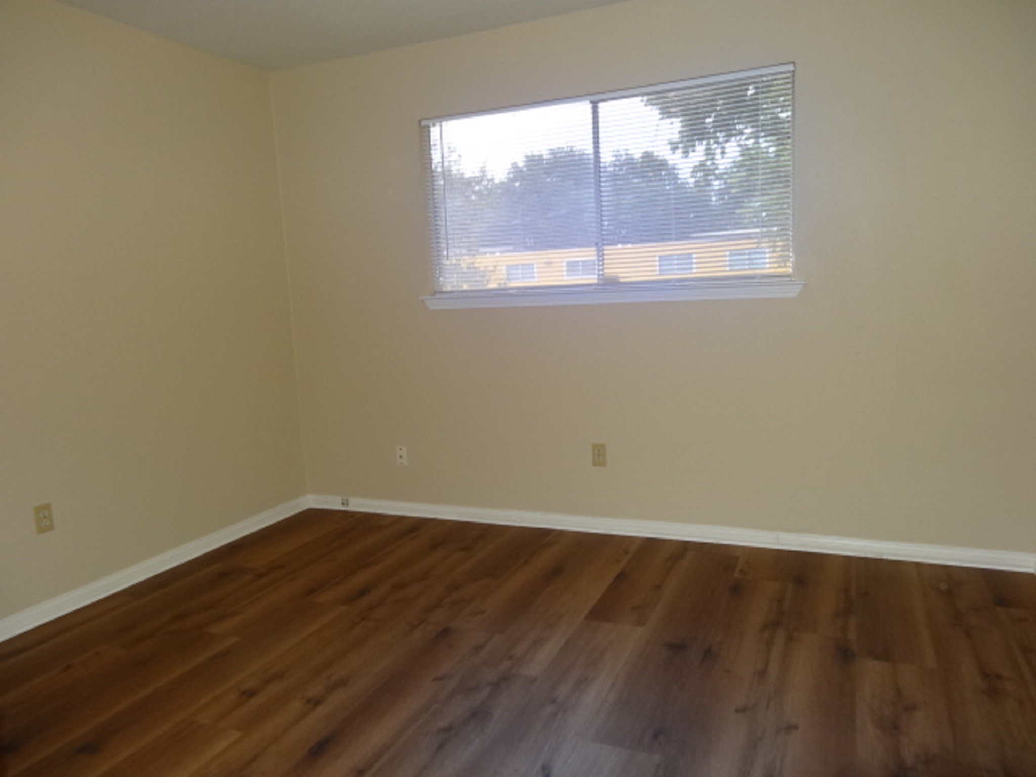 5522 Deep Forest Drive Houston, TX 77092 - Photo 28 of 47 an empty room with wooden floor and windows