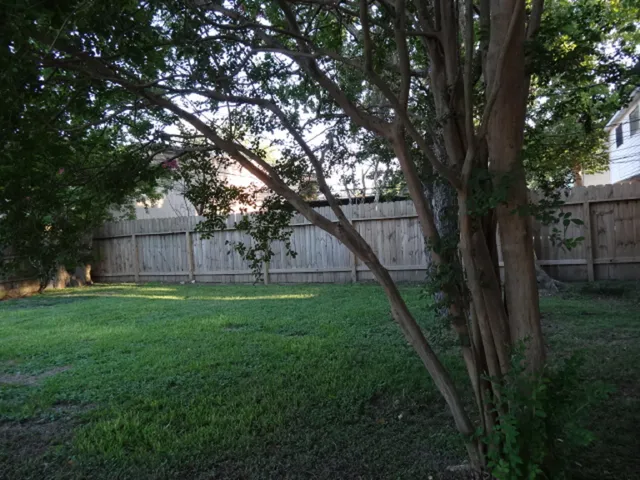 a view of a house with a backyard and a garden