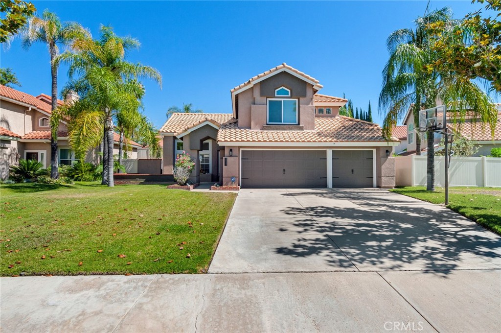 20542 Red Poppy Lane Riverside, CA 92508 - Photo 1 of 1 a front view of a house with a garden