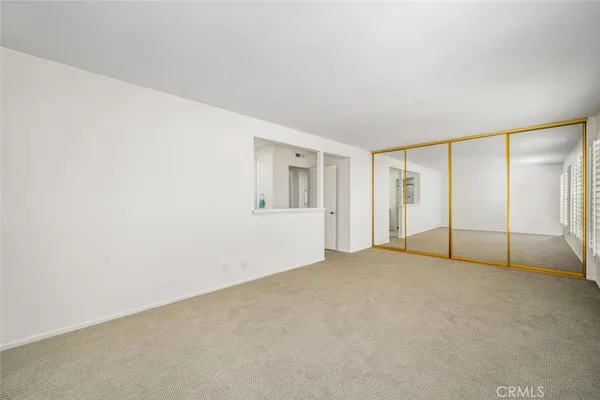 an empty room with windows and closet