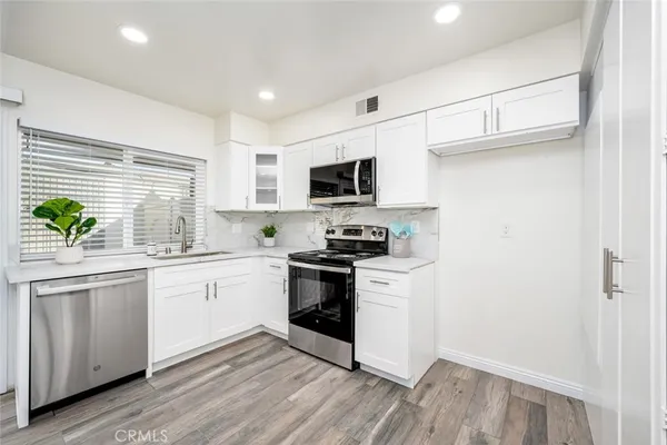 a kitchen with stainless steel appliances granite countertop a stove and a sink