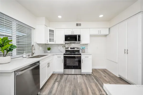 a kitchen with a sink stove and refrigerator