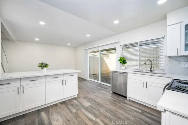 a kitchen with white cabinets and white appliances