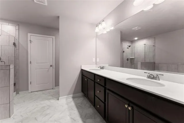 a bathroom with a double vanity sink a and a mirror