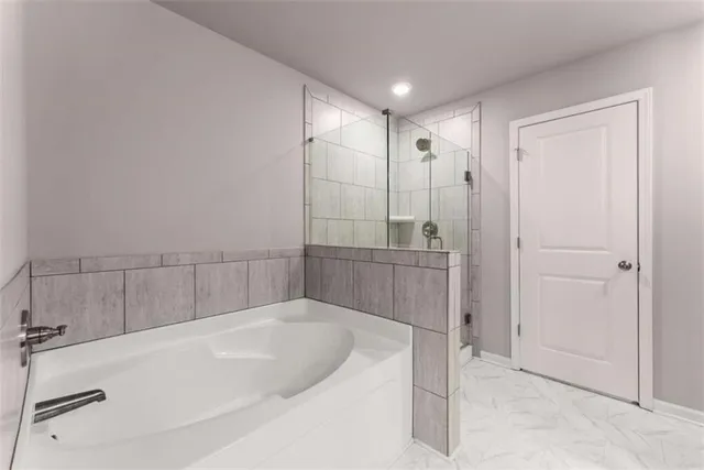 a bathroom with a bathtub and a shower