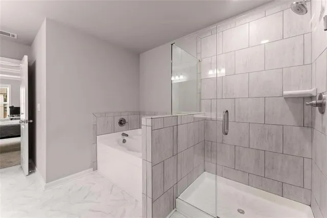 a bathroom with a bathtub and a shower