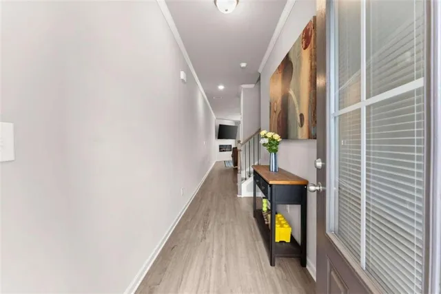 a hallway with wooden floor and furniture