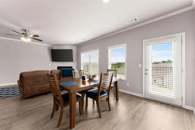 a view of a dining room with furniture window and wooden floor