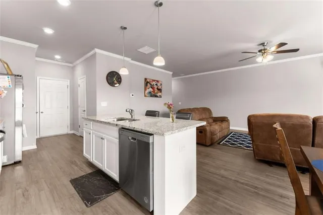 a open kitchen with stainless steel appliances granite countertop a stove and a refrigerator