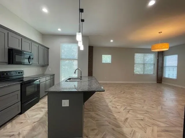 a kitchen with a sink and cabinets