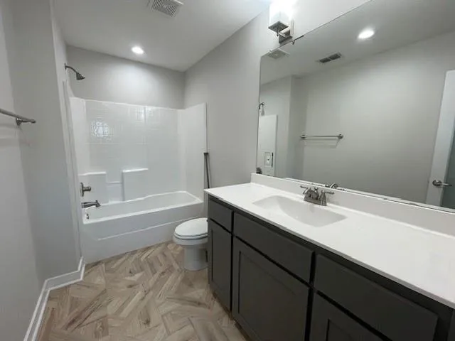 a kitchen with stainless steel appliances granite countertop a sink a stove and a wooden floors