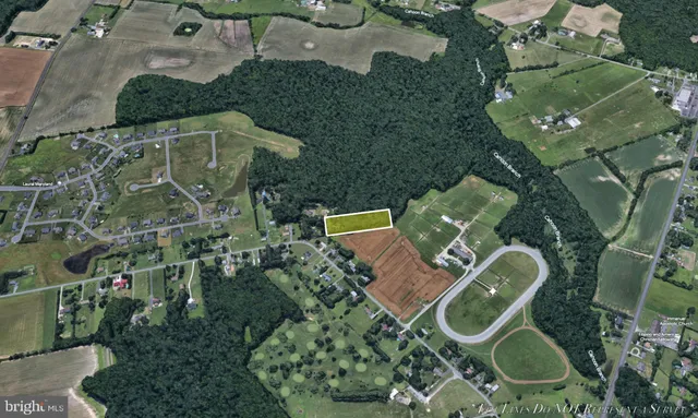 an aerial view of residential house with outdoor space and parking