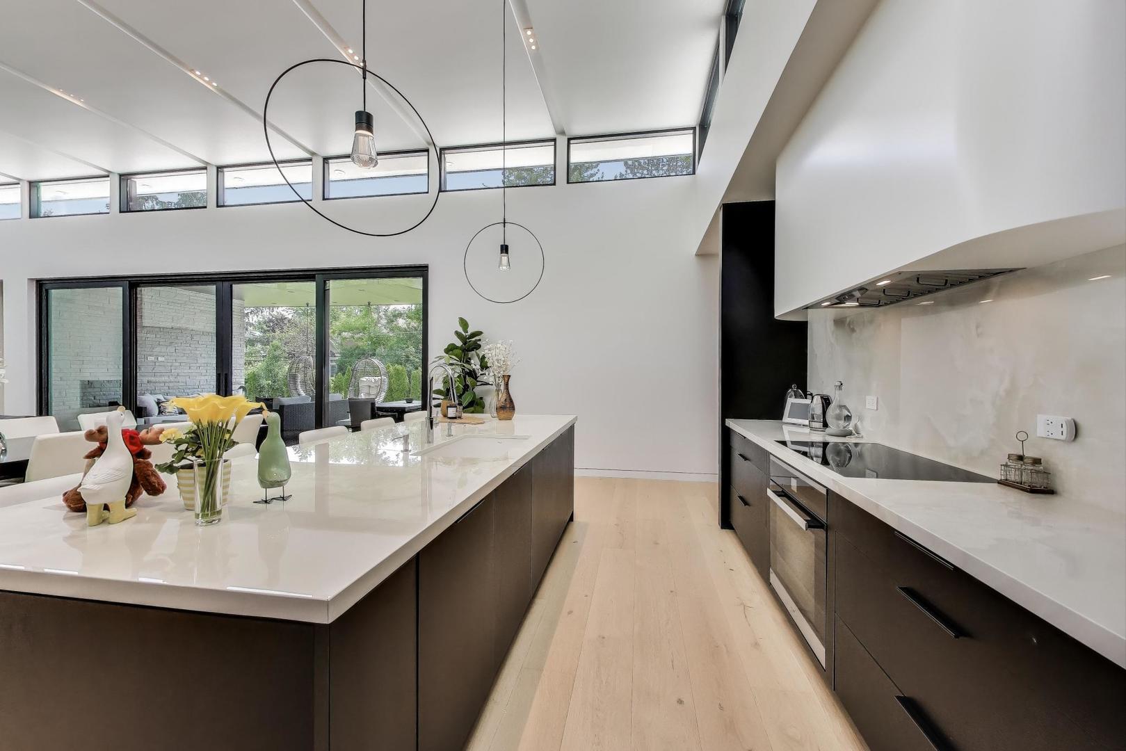 821 Harms Road Glenview, IL 60025 - Photo 13 of 41 a kitchen with stainless steel appliances a sink a counter space cabinets and furniture