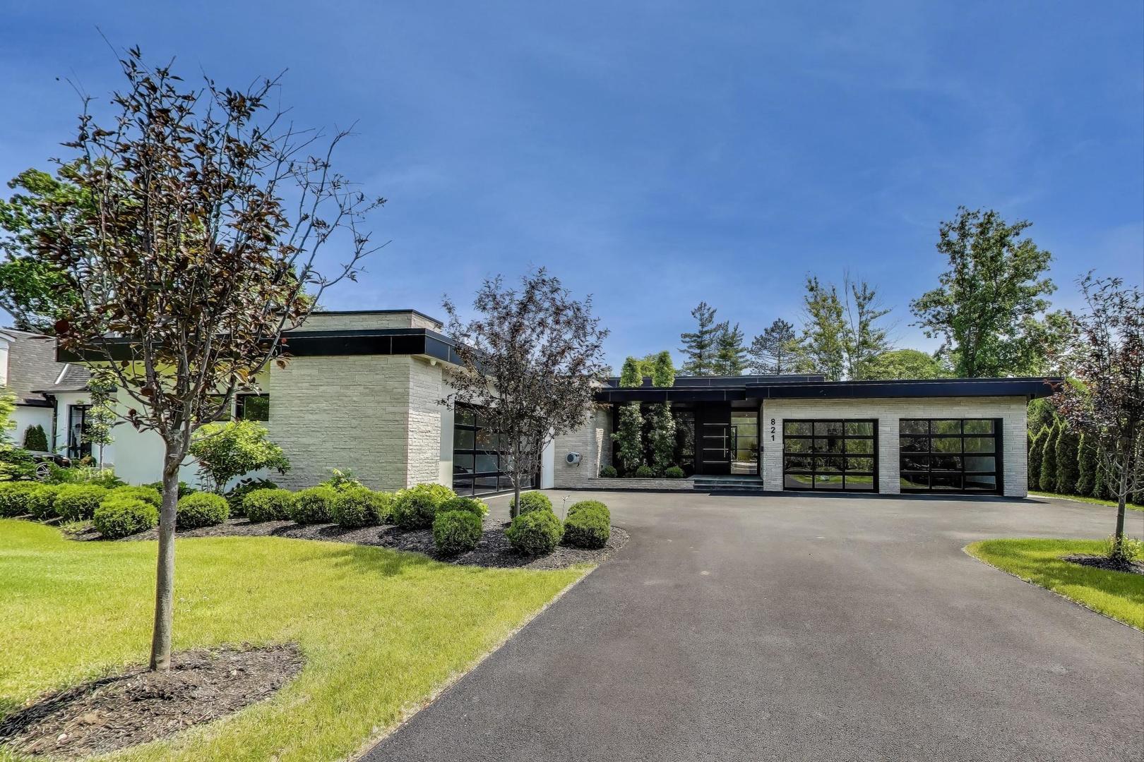 821 Harms Road Glenview, IL 60025 - Photo 2 of 41 a front view of a house with a garden