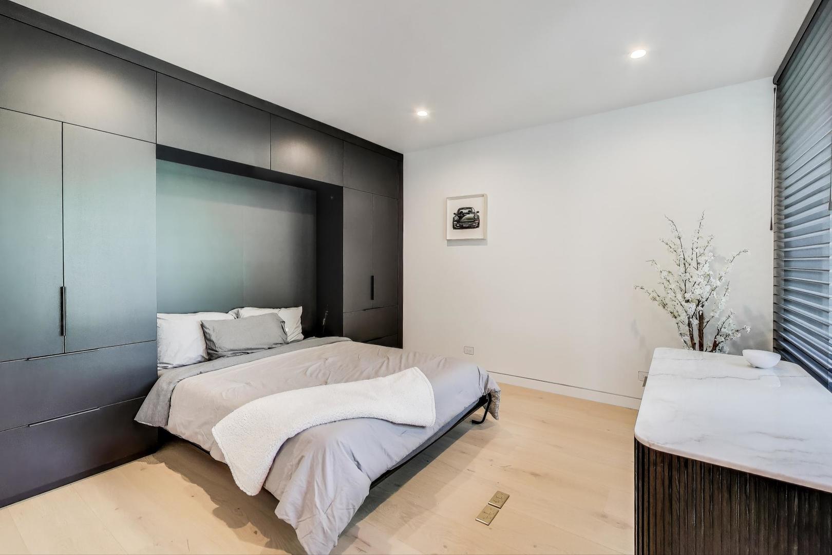 821 Harms Road Glenview, IL 60025 - Photo 29 of 41 a bedroom with a bed and a table