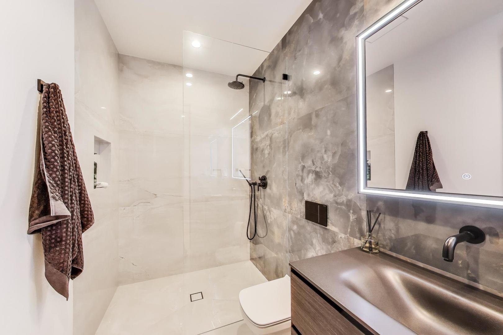 821 Harms Road Glenview, IL 60025 - Photo 30 of 41 a bathroom with a sink a toilet and shower