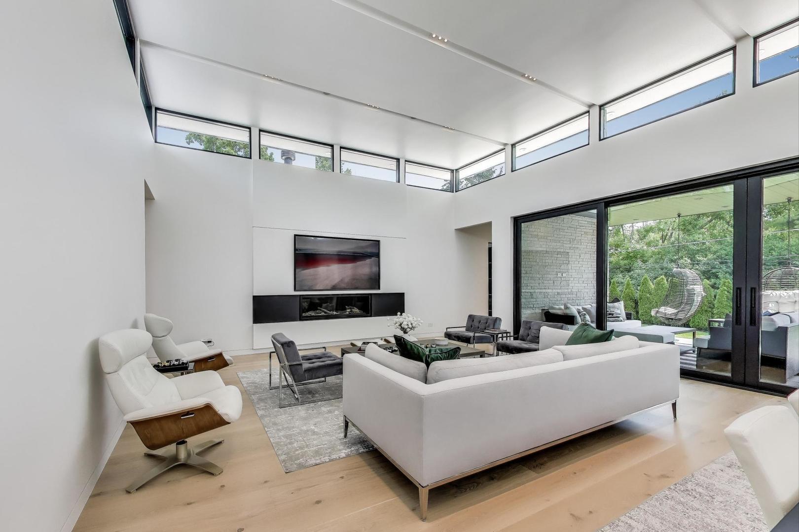 821 Harms Road Glenview, IL 60025 - Photo 10 of 41 a living room with furniture a flat screen tv and a large window