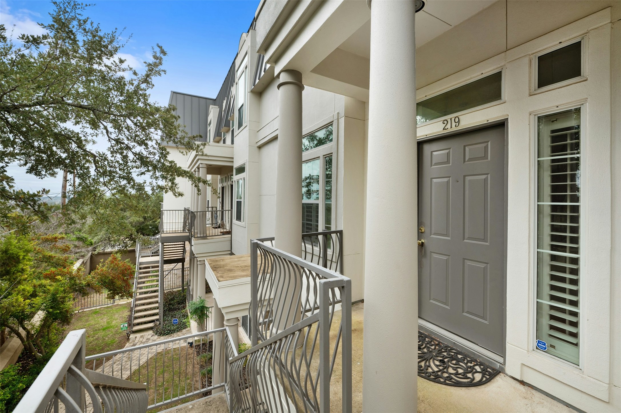 2918 Ranch To Market Road 620, Unit W219 Austin, TX 78734 - Photo 4 of 35 Step into Unit #219 - featuring a welcoming front entry with tall windows, classic columns, and curb appeal.