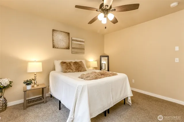 a bedroom with a large bed and a chandelier
