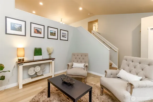 a living room with furniture fireplace and a window