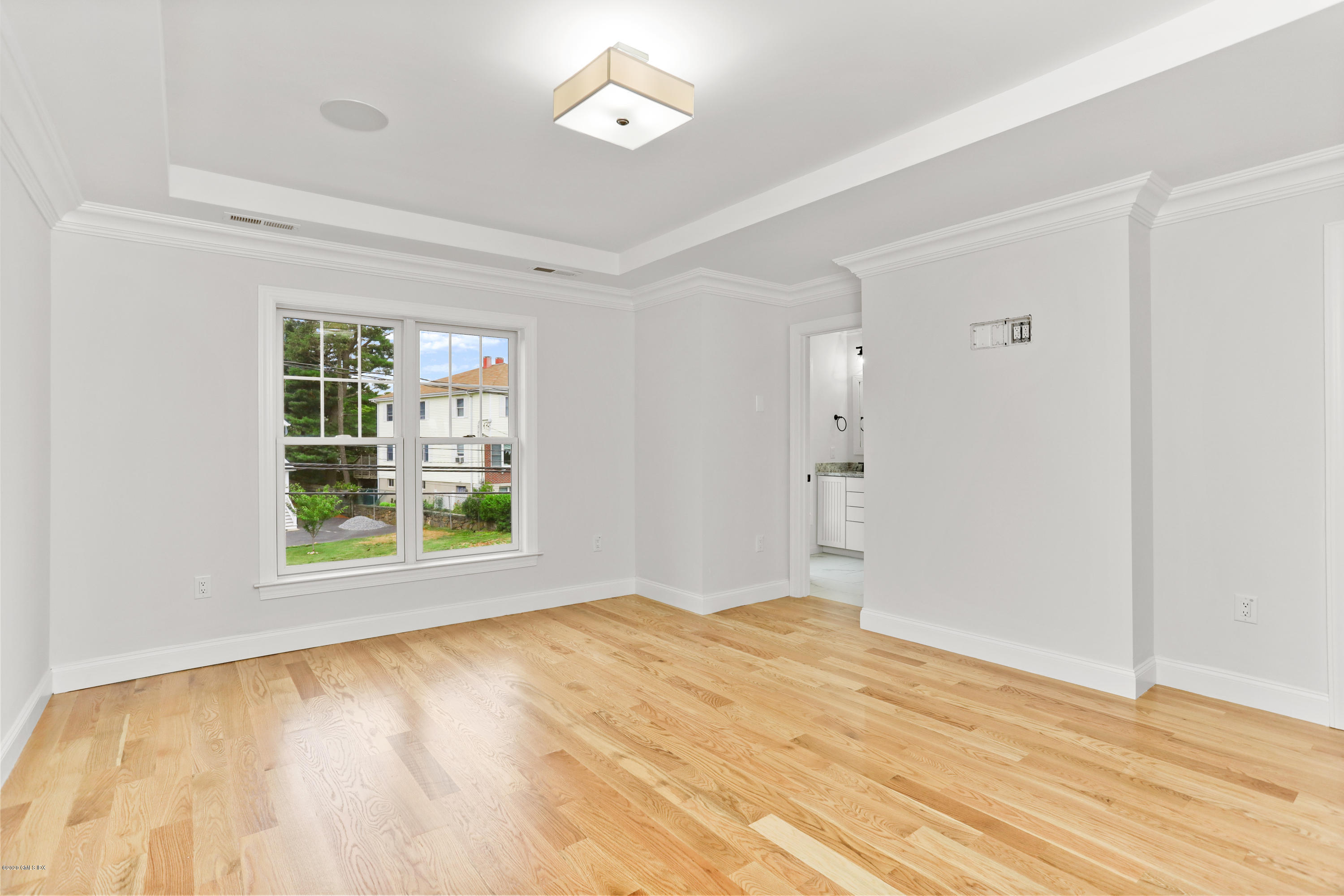 125 Hamilton Avenue, Unit 2 Greenwich, CT 06830 - Photo 15 of 20 a view of an empty room with wooden floor and a window