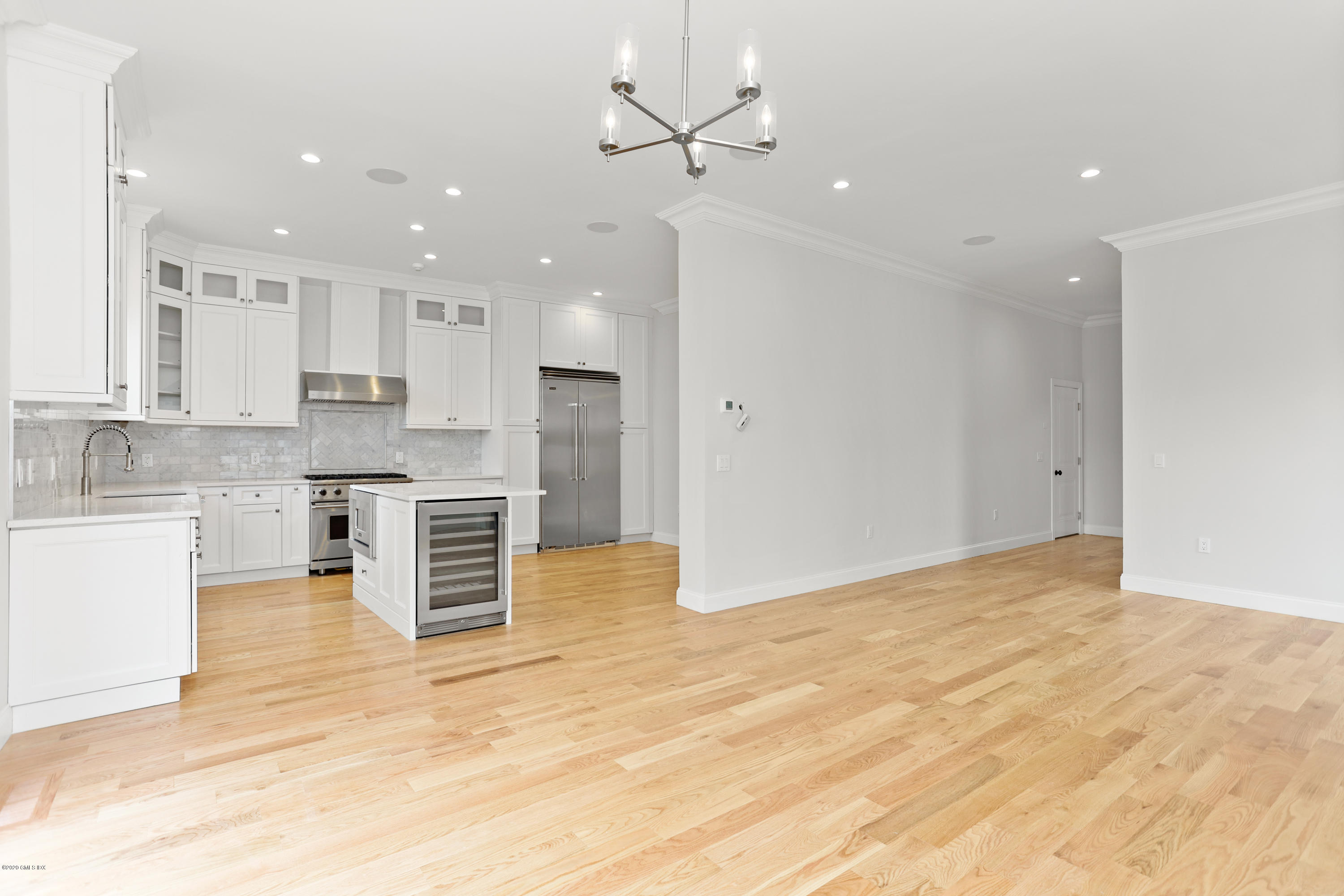 125 Hamilton Avenue, Unit 2 Greenwich, CT 06830 - Photo 4 of 20 a view of a kitchen with kitchen island a sink stainless steel appliances and cabinets
