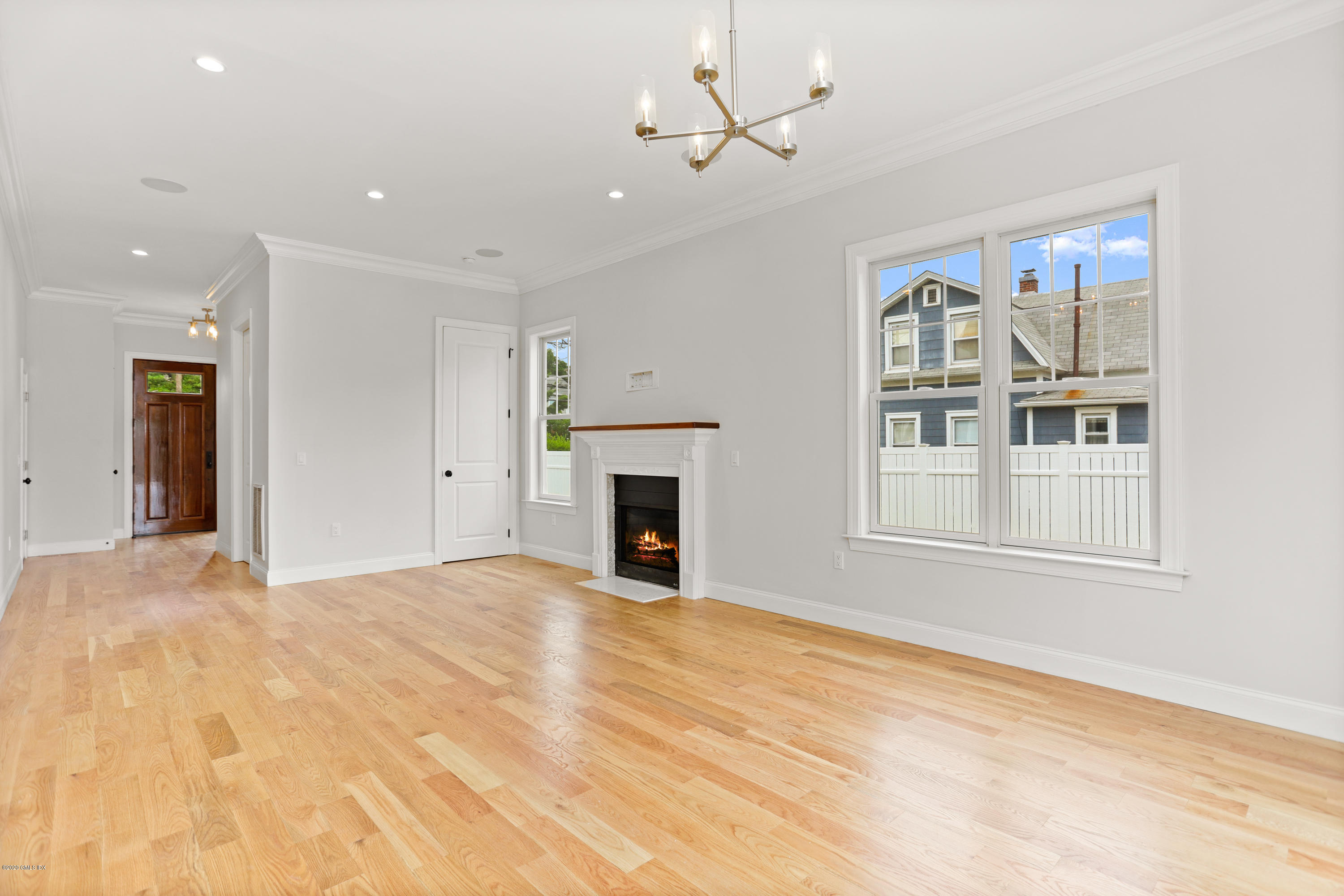 125 Hamilton Avenue, Unit 2 Greenwich, CT 06830 - Photo 5 of 20 a view of an empty room with a fireplace and a window