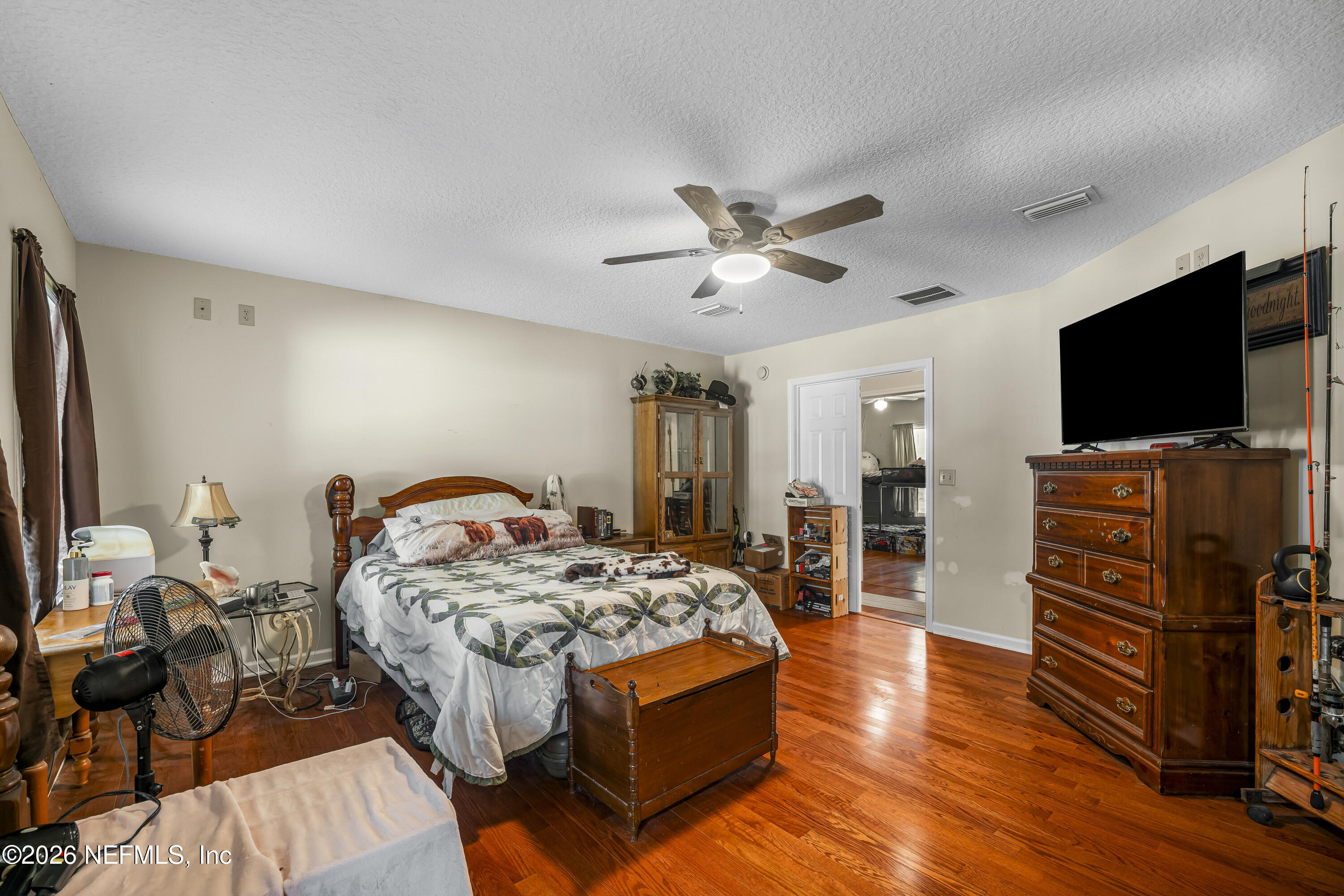 1725 Davidson Farm Road Jacksonville, FL 32218 - Photo 33 of 53 a bedroom with furniture and a flat screen tv
