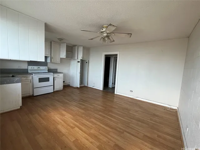 a view of a kitchen with a stove cabinets and wooden floor