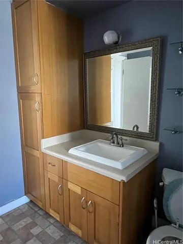 a bathroom with a granite countertop sink and a mirror