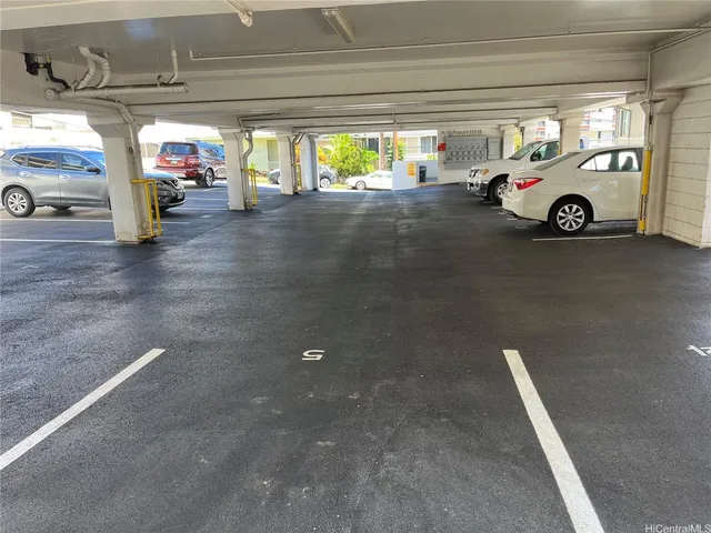 a view of parking garage with cars parked