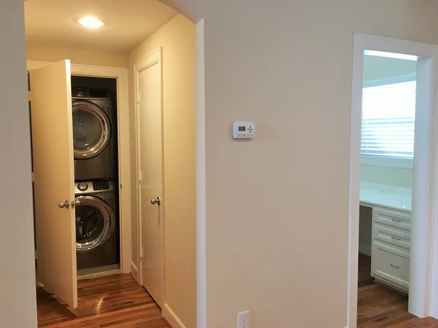 a view of a hallway with washer and dryer