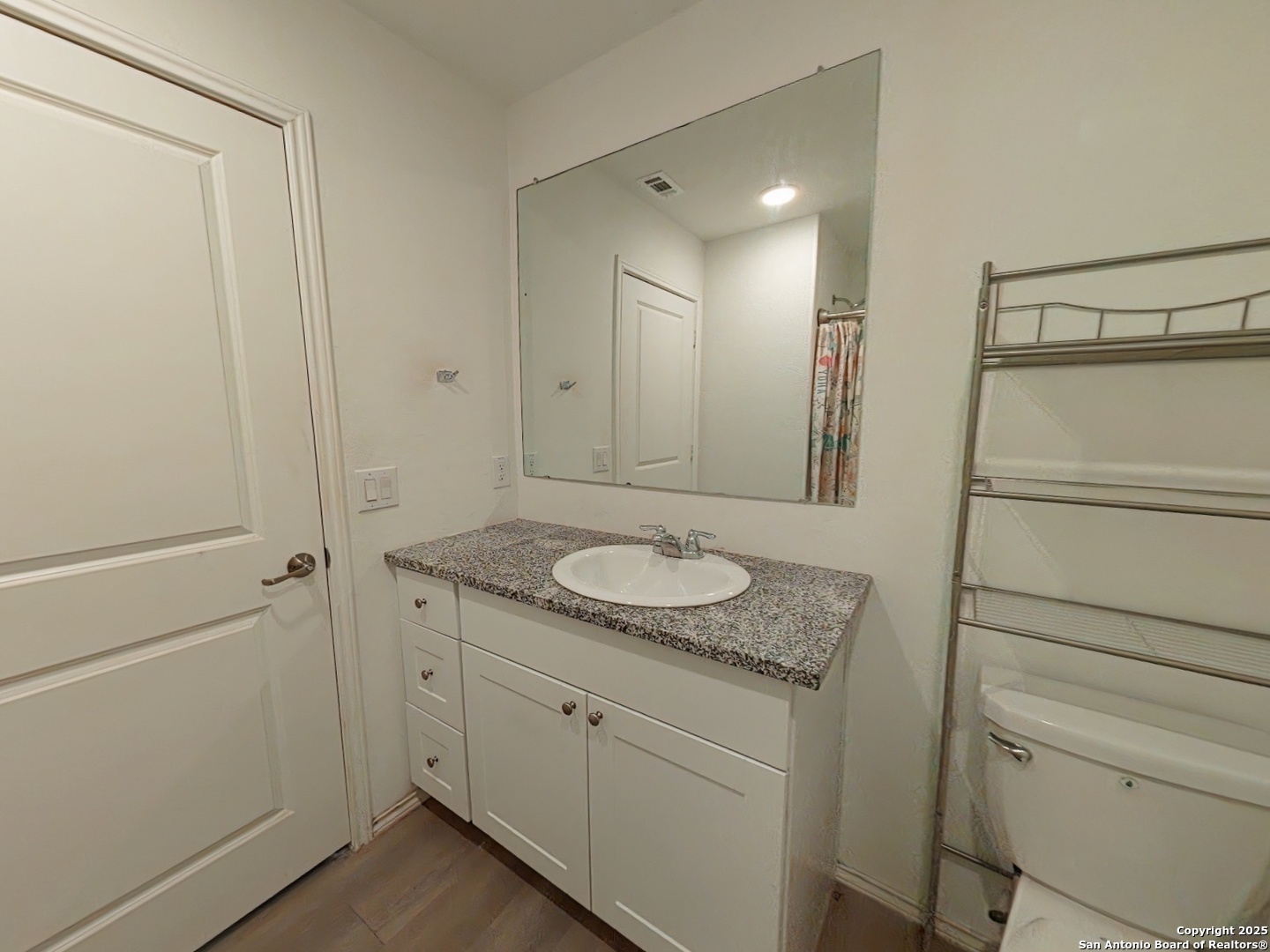 12039 Still Pass San Antonio, TX 78221 - Photo 11 of 19 a bathroom with a granite countertop sink and a mirror
